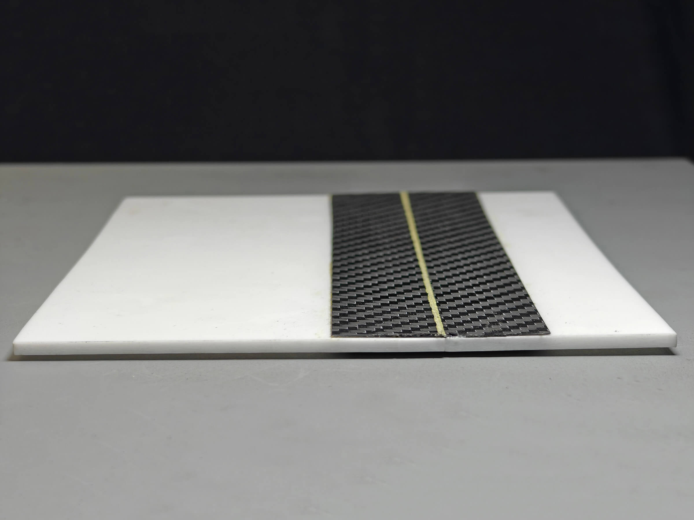 Carbon fibre panel with an integrated composite hinge, lying flat
