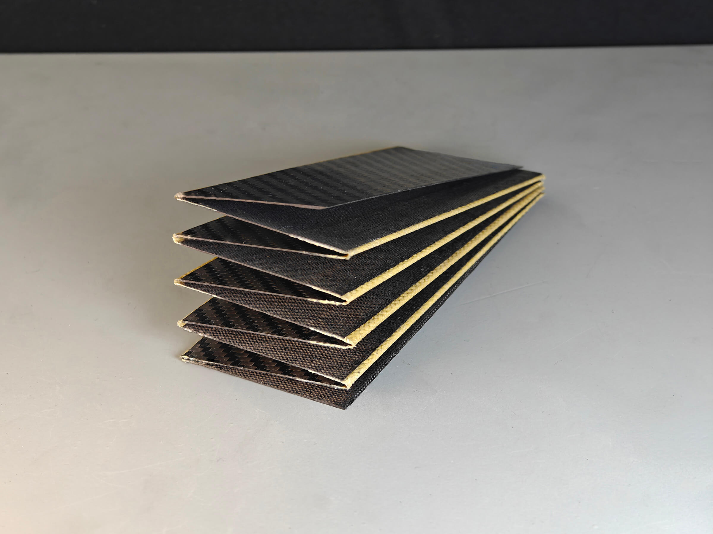 Multi-panel carbon fibre sheet folded flat on its composite hinges