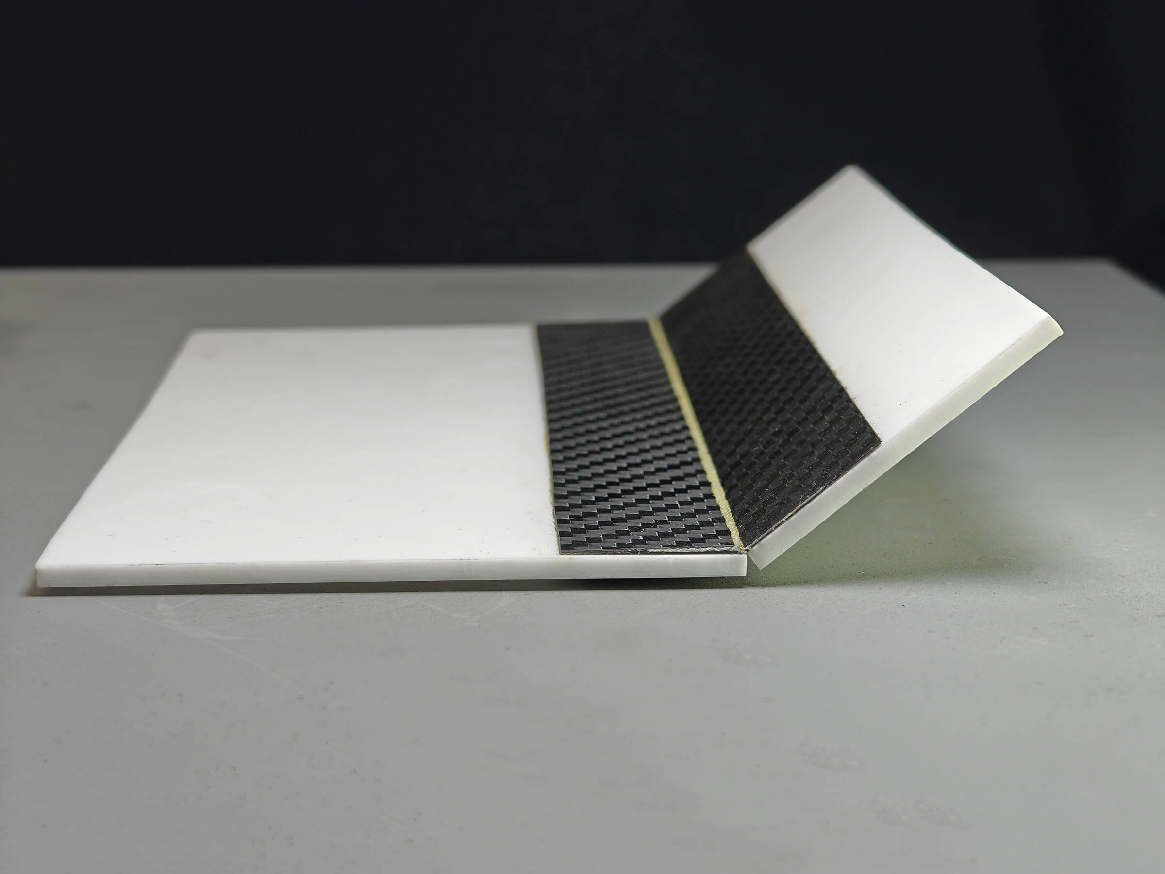 Carbon fibre panel with an integrated composite hinge, flexed